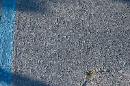 Old and weathered asphalt texture with traces of paint, cracked ground