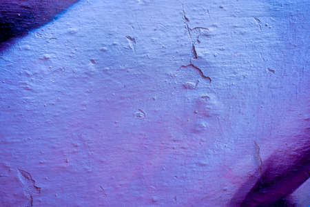 Blue and violet abstract paint on a white cracked wall. Close-up of a graffiti texture. Street art...
