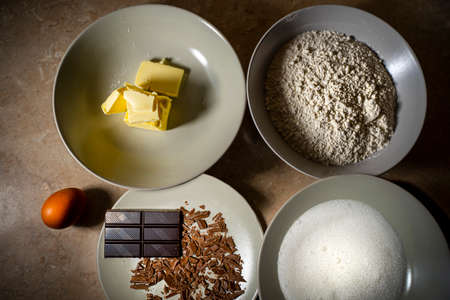 Ingredients for sweet recipe. Egg, butter, flour, chocolate, sugar. Top viewの写真素材