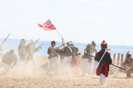 Malaga, Spain - October 26, 2014: 18th century troops of the Royal Navy fight against French soldiers. Historical reenactment of the British landing of 1812. Assault on a Napoleonic corsair base.のeditorial素材