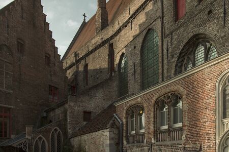 Detail view of gothic brick buildings with windows, typical of Belgium, Netherlands, Holland and Brugesの写真素材