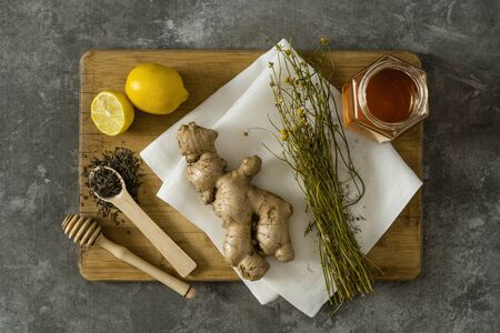 Materials to prepare ginger tea with honey and pollen on concrete tableの写真素材