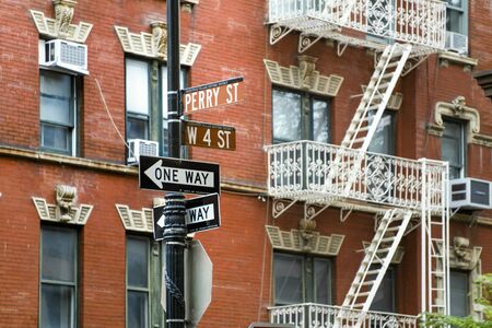 New York One way street signs with stairs in the background