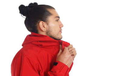 Young hispanic man with gathered hair done bow wearing black t-shirt and red jacket, hands...