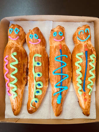 GUAGUA DE PAN - Bread boy in Spanish language - Group of breads decorated with colored lines inside...
