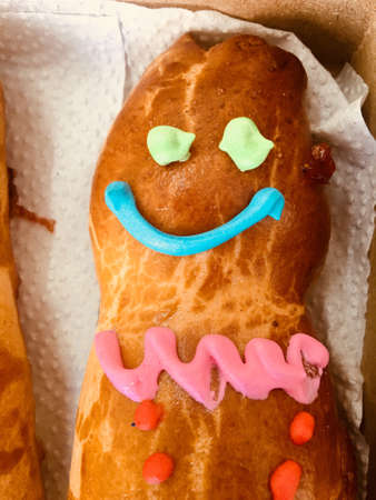 GUAGUA DE PAN - Bread boy in Spanish language - Approach to the decorated bread head on white...