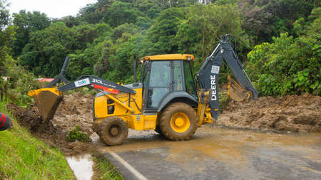 El Chaco, Napo / Ecuador - January 2 2020: A loader - heavy equipment machine - cleaning a landslide...