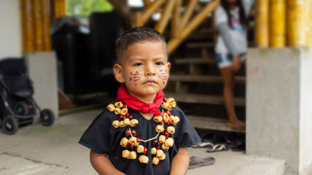 Lago Agrio, Sucumbios / Ecuador - February 20 2020: Child of the Cofan ethnic group wearing their traditional clothing adorned with a necklace made with seeds in the Cofan Dureno millennium communityのeditorial素材