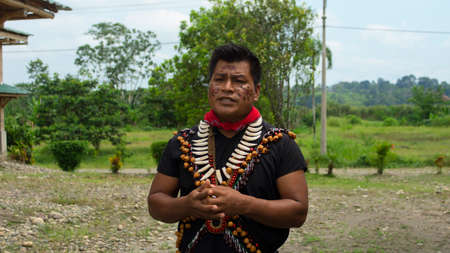 Lago Agrio, Sucumbios / Ecuador - February 20 2020: Cofan ethnic man talking in traditional clothing in the Cofan Dureno millennium community located on the edge of the Aguarico riverのeditorial素材
