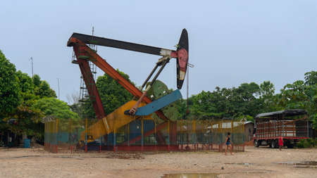 La Dorada, Putumayo / Colombia - March 8 2020: Women walking near a producing oil well near La Dorada village on a sunny dayのeditorial素材