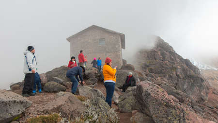 Cayambe, Pichincha / Ecuador - February 24 2020: Group of tourists looking at the landscape of the Cayambe volcano near the Ruales Oleas Berge refugeのeditorial素材