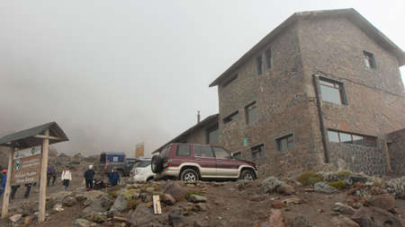 Cayambe, Pichincha / Ecuador - February 24 2020: Group of tourists walking near the Ruales Oleas Berge refuge located next to the Cayambe volcanoのeditorial素材