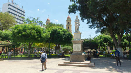 San Miguel de Piura, Piura / Peru - April 5 2019: People walking in the Plaza de Armas with the...