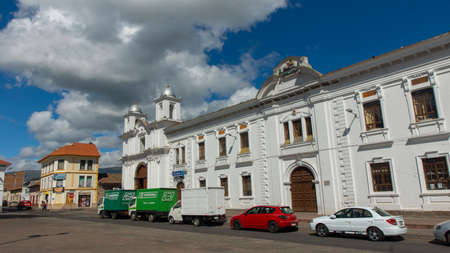 Latacunga, Cotopaxi / Ecuador - June 5 2021: People walking near the church of San Agustin in the center of the city of Latacunga on a sunny dayのeditorial素材