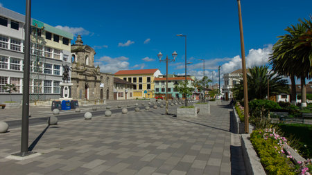 Latacunga, Cotopaxi / Ecuador - June 5 2021: People walking in front of the San Francisco church in the center of the city of Latacunga on a sunny dayのeditorial素材