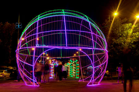 Quito, Pichincha, Ecuador - January 1 2022: Tourists walking at night through the streets of the city of Quito with Christmas lights decorationのeditorial素材