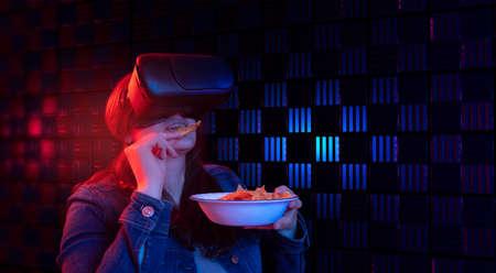 Hispanic woman with virtual reality goggles with digital technology watching a 3D movie in...