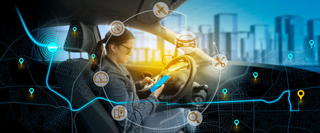 City map with route marked with pins and icons of car, satellite, mechanic with background of young woman sitting behind the wheel of her vehicle checking the route of her trip on her smartphoneの写真素材