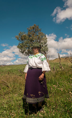 Cangahua, Cayambe / Ecuador - September 12 2023: Portrait of elderly indigenous woman from Cayambe walking through the field during the dayのeditorial素材