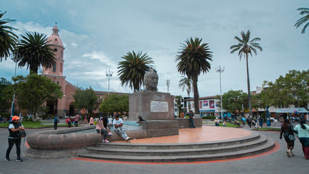 Otavalo, Imbabura / Ecuador - October 14 2023: People walking in front of the Ruminahui monument in the central park of Otavalo with the cathedral in the backgroundのeditorial素材