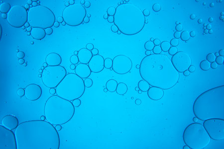 Abstract composition with water, bubbles and oil drops against a blue backgroundの写真素材