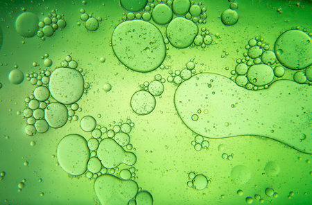 Abstract composition with water and oil drops against dark green backgroundの写真素材