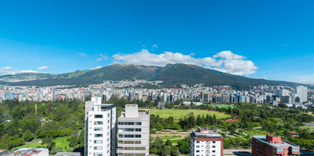 Panoramic view of La Carolina Park surrounded by modern buildings in the northern part of Quito with the Rucu Pichincha volcano in the backgroundの写真素材