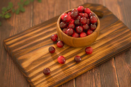 Cranberry culinary in home kitchen. Cranberry mocktail ingredients for make natural beverage and drink. Fresh red berries in wooden bowl.の写真素材