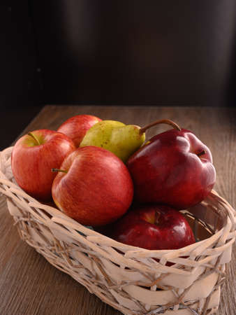 Photo shows several apples and one pear. Photo was taken in studio using special light. Red apple glistens like glossy - this is natural effect.の写真素材