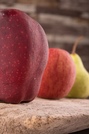 Photo shows several apples and one pear. Photo was taken in studio using special light. Red apple glistens like glossy - this is natural effect.の写真素材