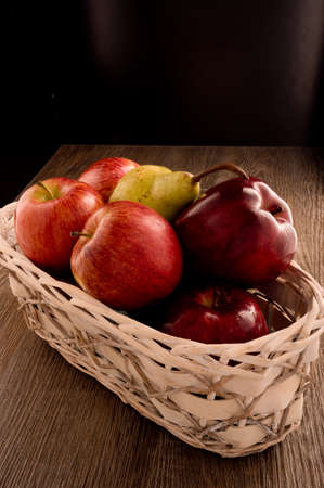 Photo shows several apples and one pear. Photo was taken in studio using special light. Red apple glistens like glossy - this is natural effect.の写真素材