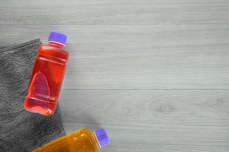 Electrolytes beverage for hydro balance. Tonic energy liquid. Photo taken with wooden surface background. Electrolytes sodium in plastic bottle. Tonic energy drink, copy space, flat lay. Electrolyte solution in recycle tara.の写真素材