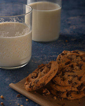 Light breakfast for the whole family with milk and diet biscuits. This snack will provide energy and potential for the whole day. The photo is made in light colors and sunlight.の写真素材