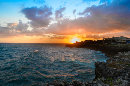 Perfect sunset on atlantic ocean shore. rocky bay in the evening Fall down on caribbean island before night. Relax time and reatreat place for meditation and for family resort.の写真素材