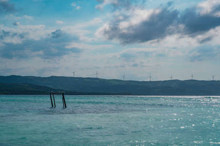 Photo of a sandy beach in the foreground from the Dominican Republic. The picture clearly shows the...