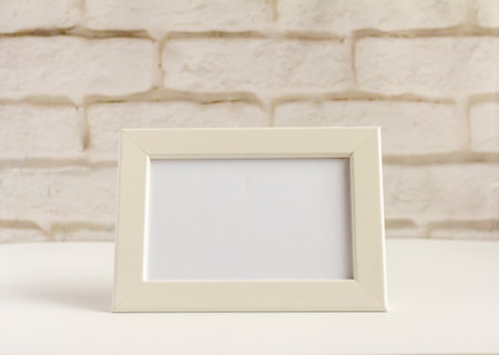 An empty photo frame on a table or shelf with a copy of the space.の写真素材