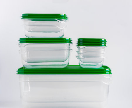 Empty plastic food containers are stacked on a white background.の写真素材