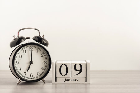 December 25 on a white wooden calendar on a wooden background next to the Christmas tree.の写真素材