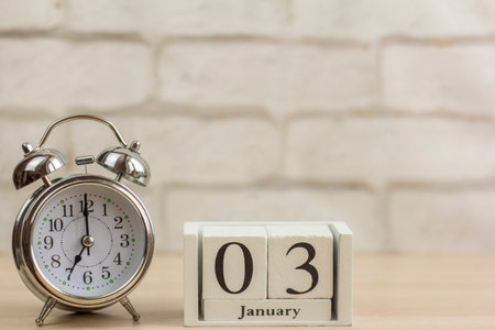 January 3 on a wooden calendar next to the alarm clock.One day in January.Winter day.Copy of the space.の写真素材