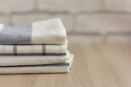 A stack of folded kitchen towels lies on the surface.の写真素材
