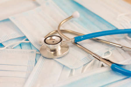 Stethoscope and masks on the table, the concept of  viruses.の写真素材