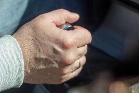 A man's hand on the gearbox in the car.Close-up