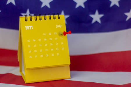 Flip calendar for July 2021. Desktop calendar with a highlighted date of July 4 on the background of...