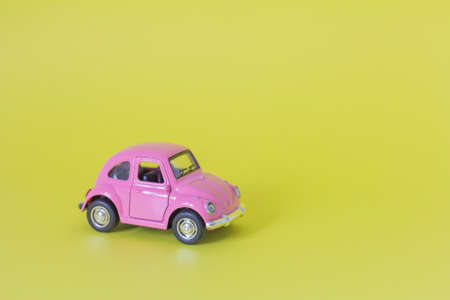 20.07.2021-Zavyalovo.A small pink metal car on a yellow backgroundの写真素材