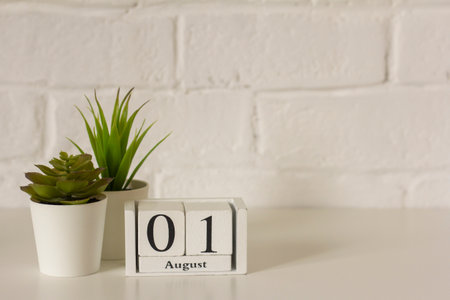 August 1.The 1st day of the month, a wooden perpetual calendar at the workplace. Hello August. Empty space for the textの写真素材