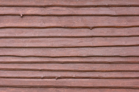 A dark wooden background made of rough rough boards, nailed overlapping