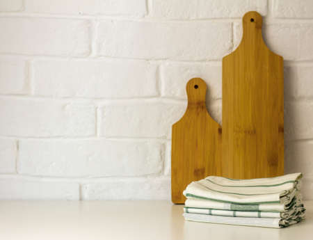 Kitchen clean towels and cutting boards on the table with a copy of the space