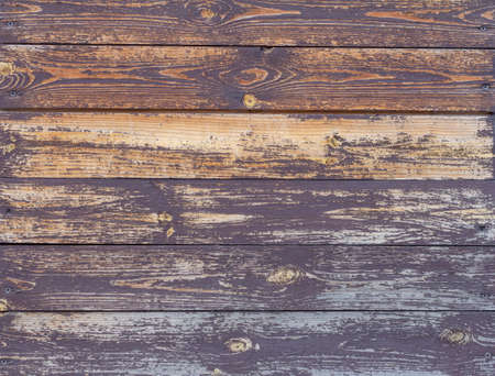Wooden background.The texture of an old wooden wall with cracked brown paint