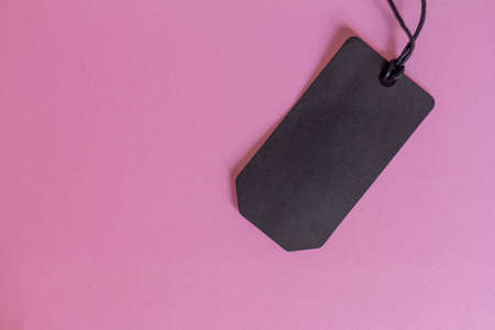 Mock up cardboard blank tag with place for text on pink background. Sale conceptの写真素材