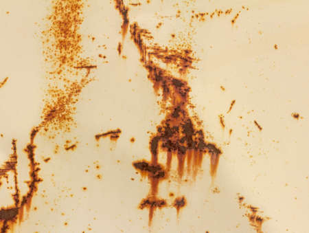 A rusty white metal wall. Metal background with streaks and rust spots. There are rust spots on the...